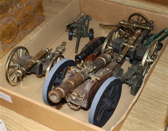 A group of brass cannons and toy artillery